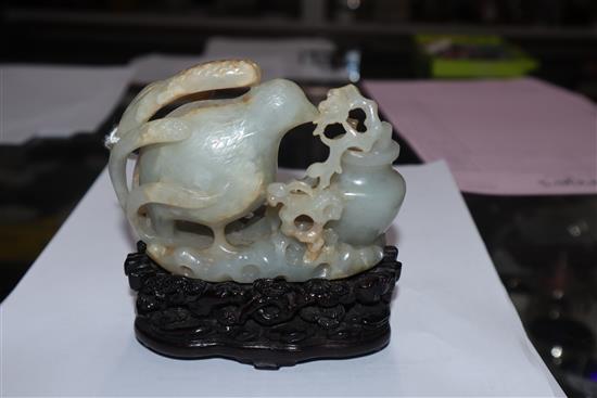 A Chinese pale celadon and russet jade quail carving, wood stand 10cm high including stand